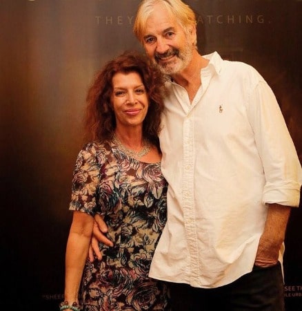 A smiling picture of John Jarratt in white shirt with his wife Rosa Miano
